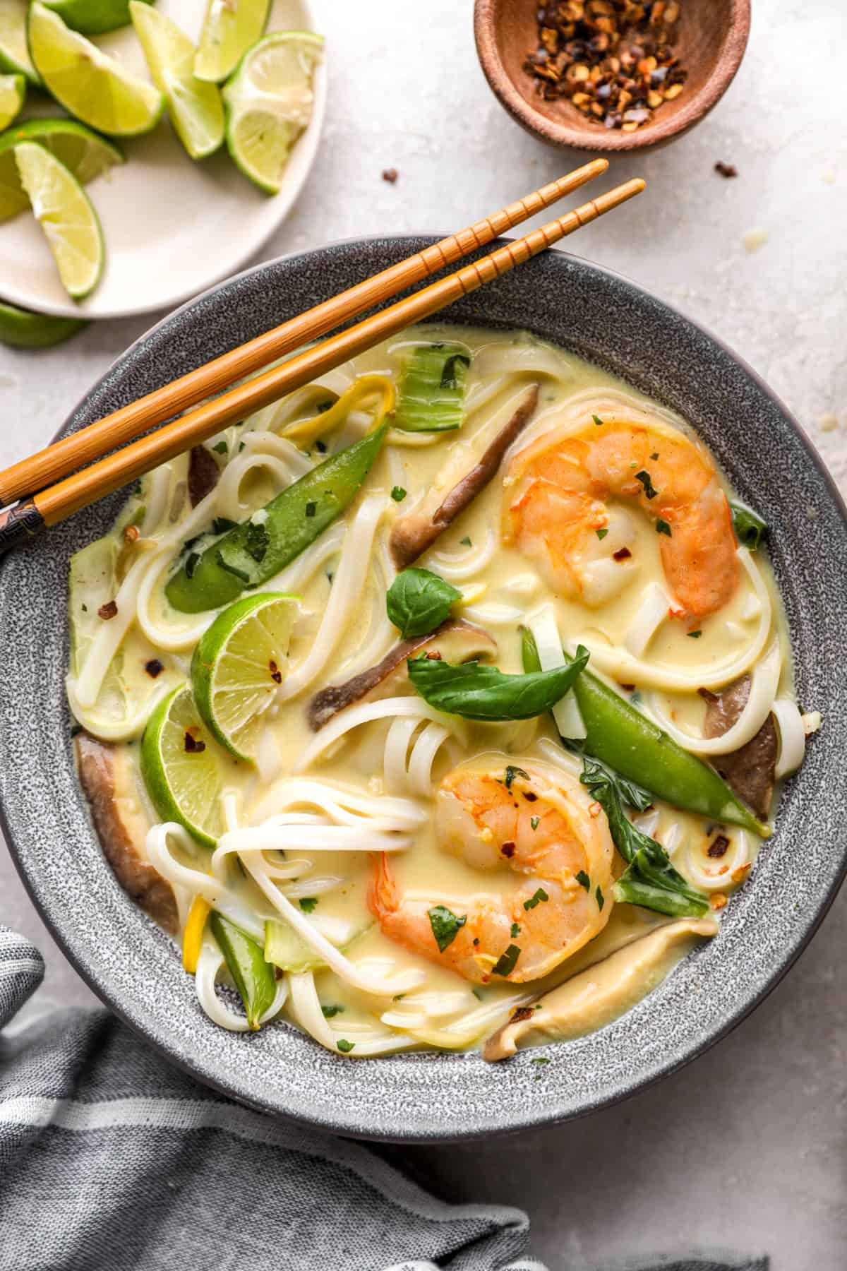 A bowl of Thai curry soup with shrimp.