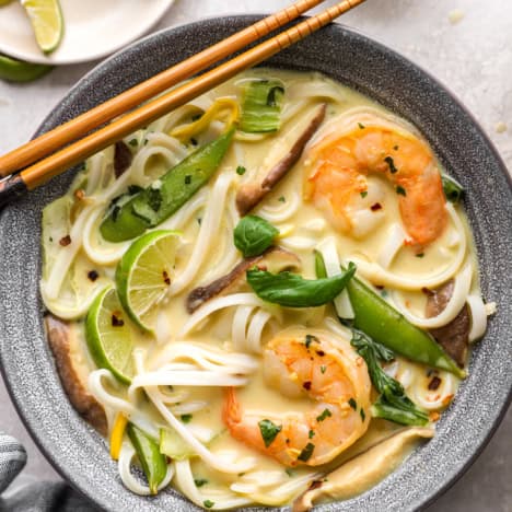 A bowl of Thai curry soup with shrimp.