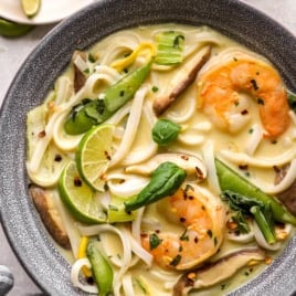 A bowl of Thai curry soup with shrimp.