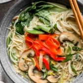 A bowl of coconut curry ramen with chopsticks on top.