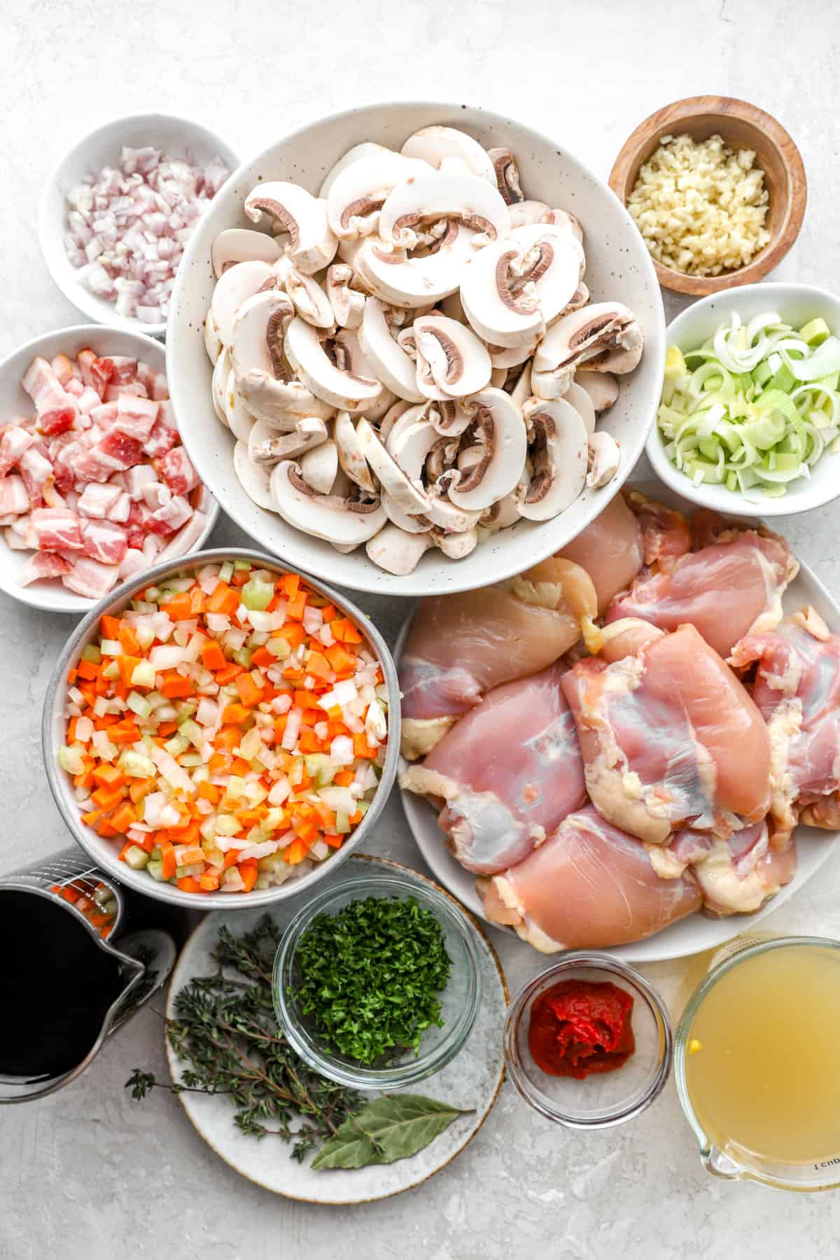 Ingredients to make chicken coq au vin with leeks and mushrooms. 