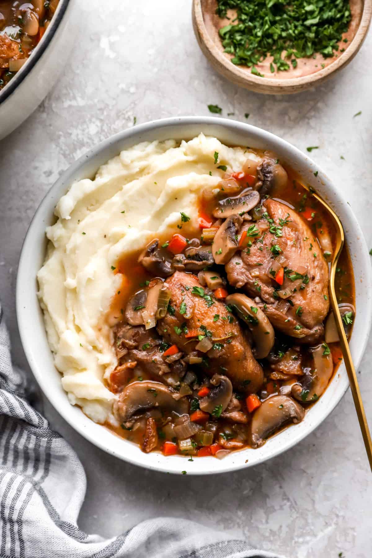 Chicken coq au vin served over mashed potatoes. 