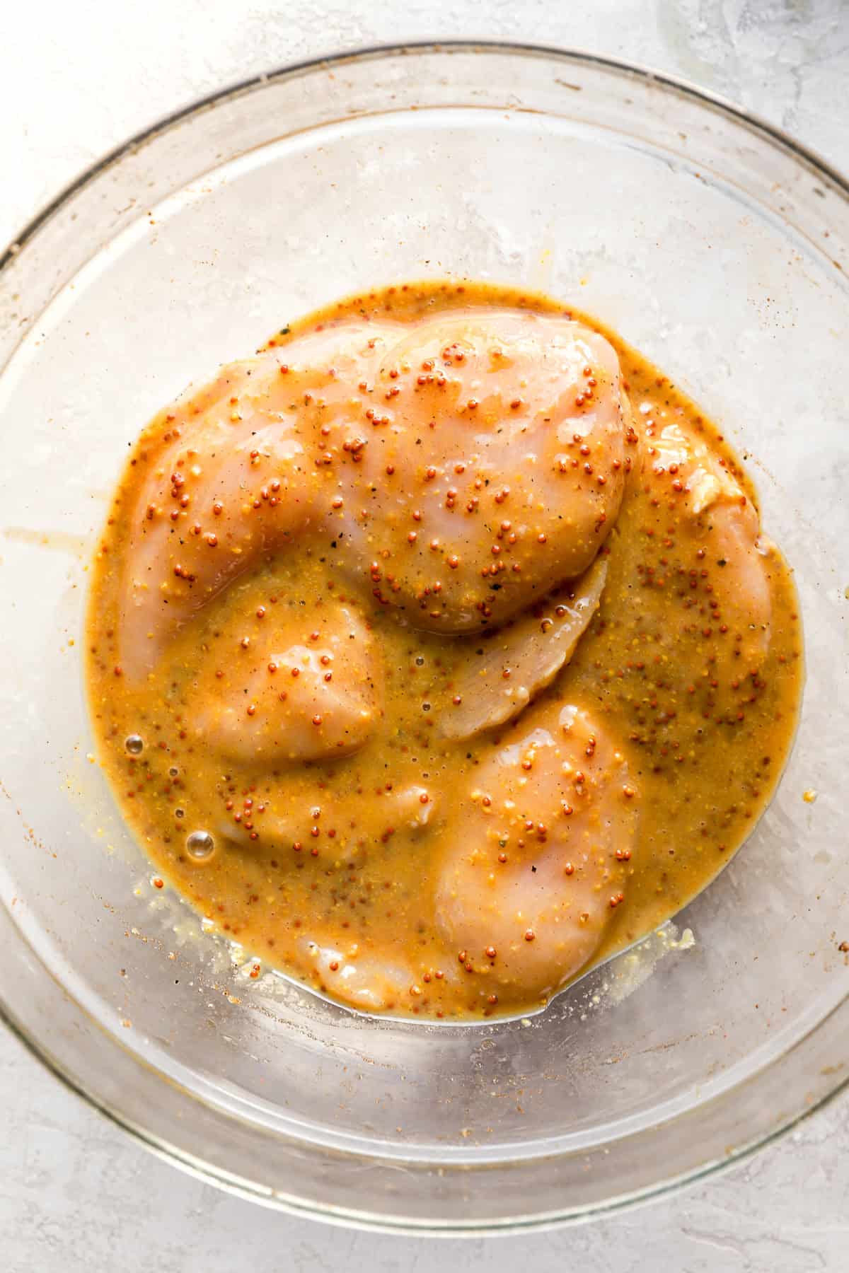 Raw chicken marinating in honey mustard. 