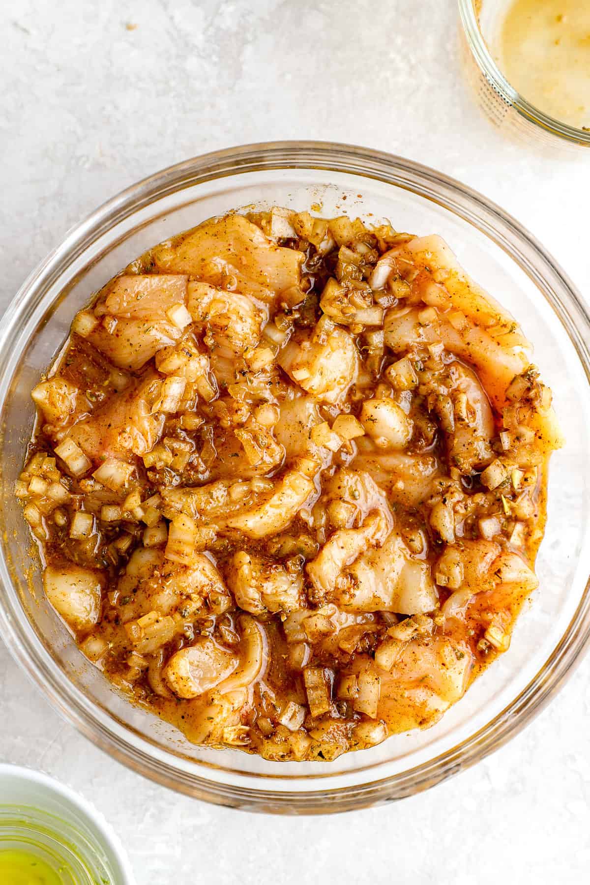 Chicken marinating in a bowl. 