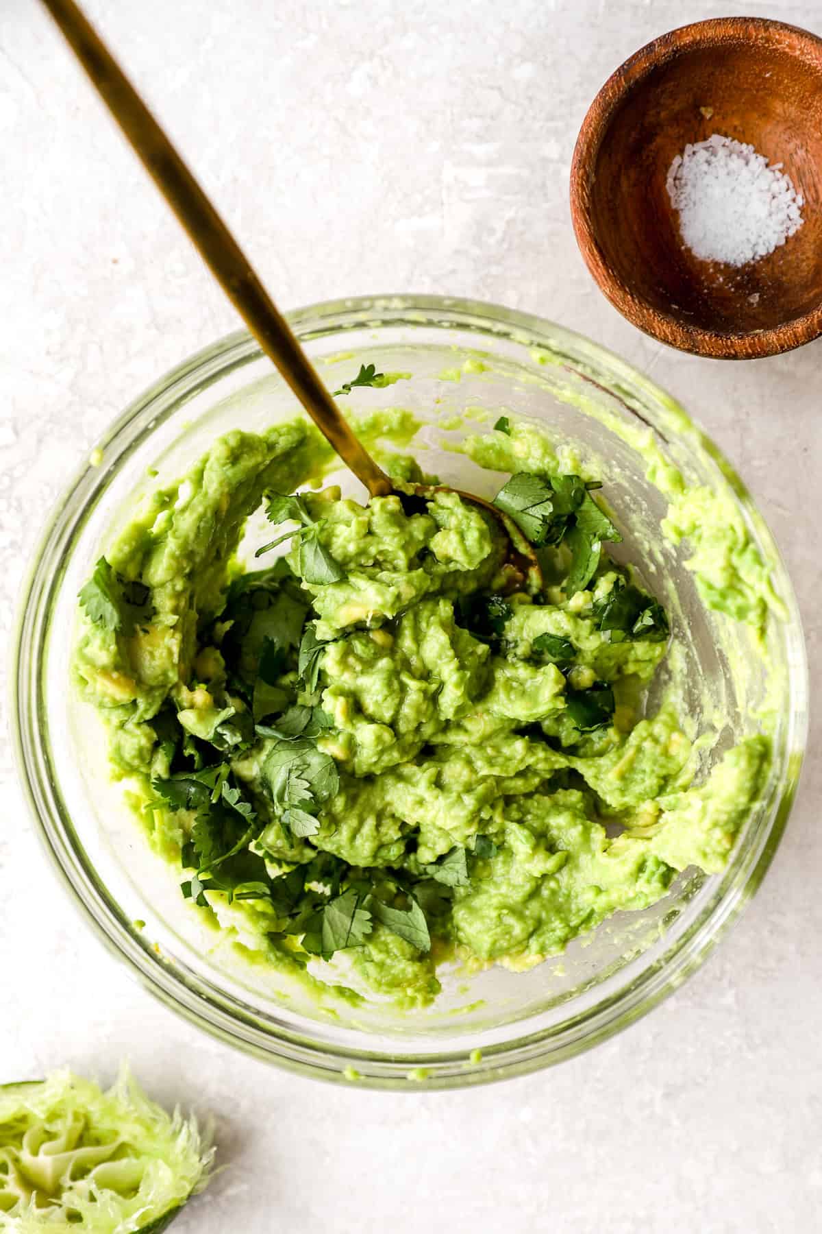 Guacamole being stirred in a bowl. 