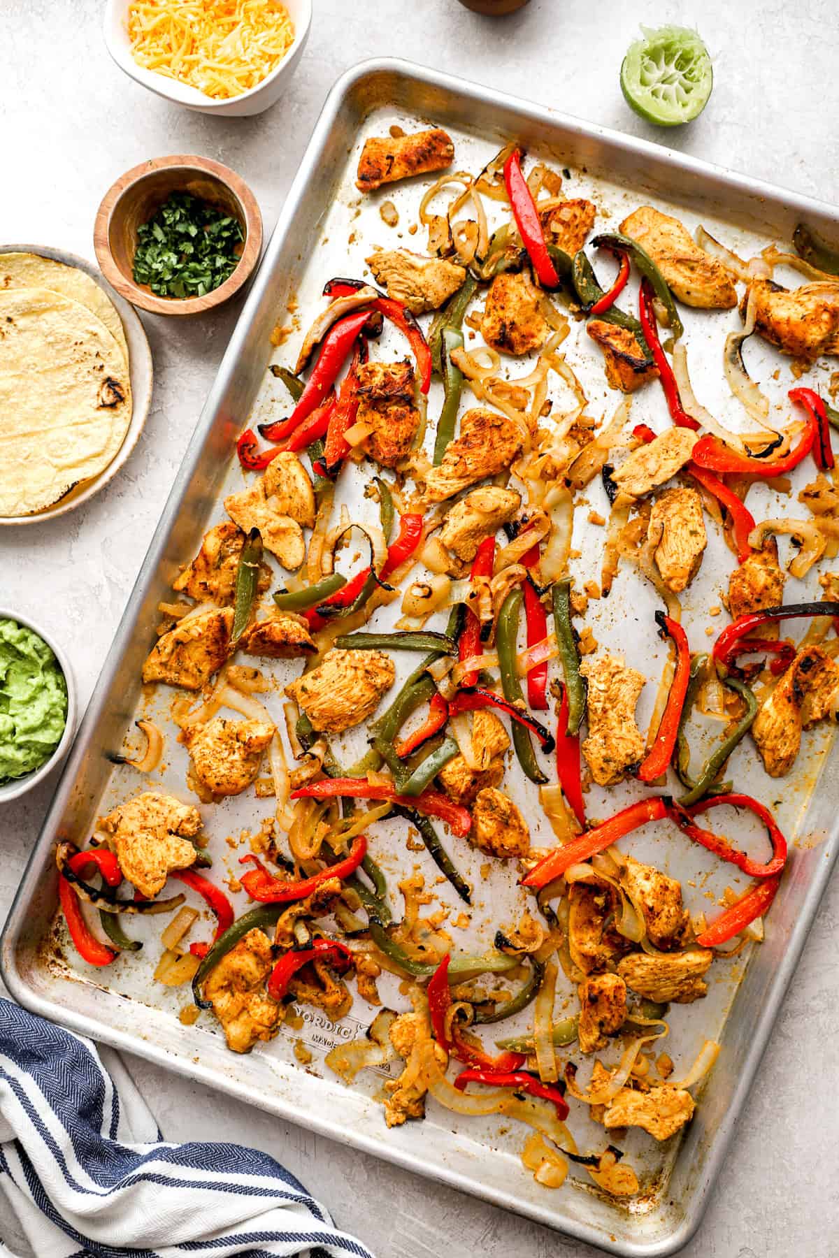 Fajita chicken, peppers, and onions on a sheet pan. 