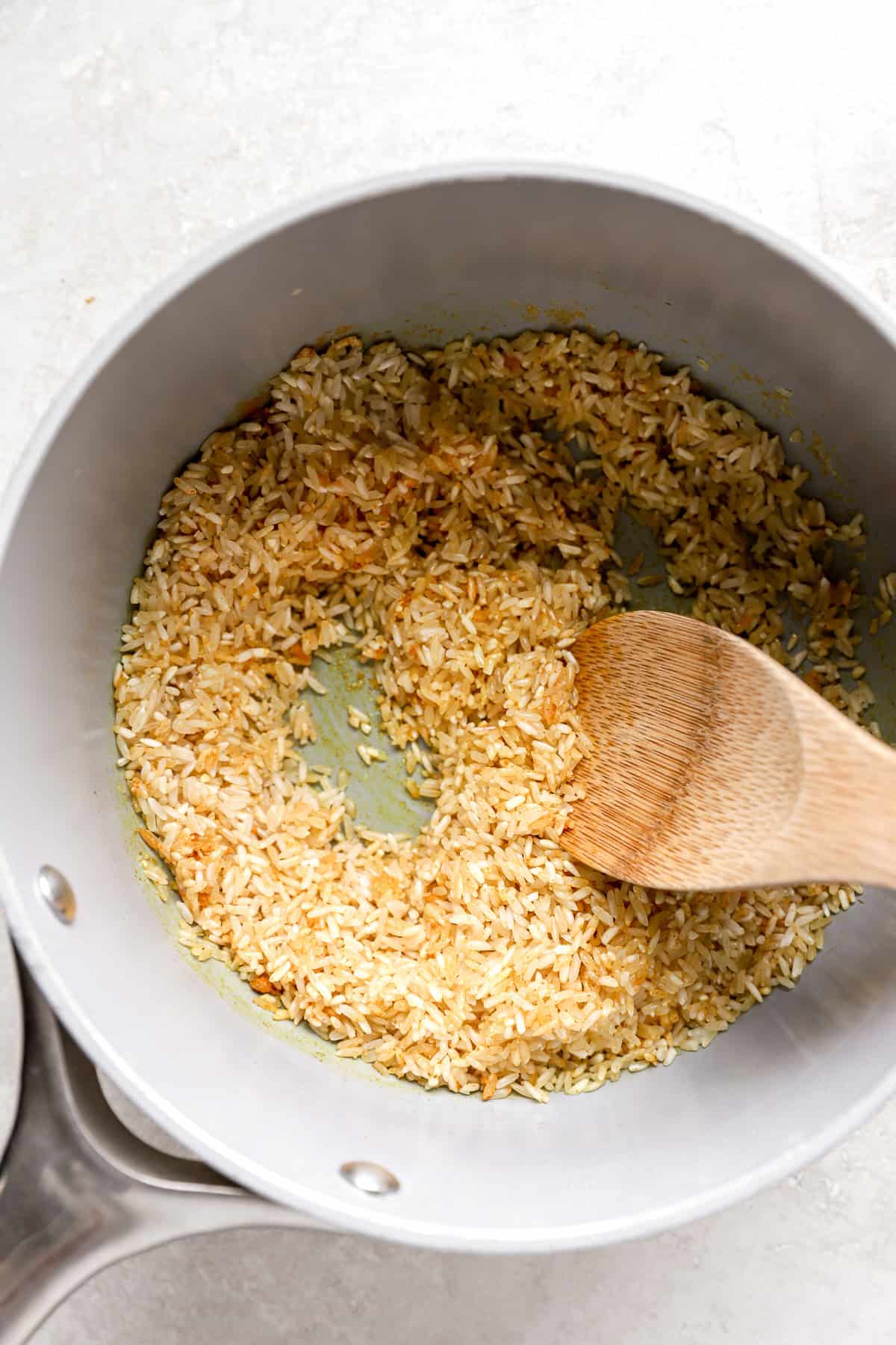 Rice toasting in oil with spices. 