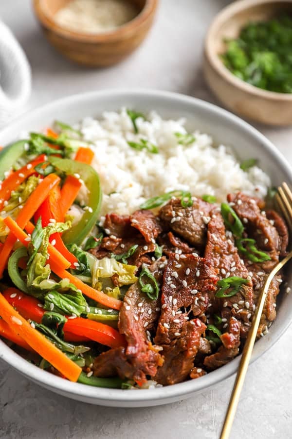 Instant Pot Mongolian Beef and peppers with rice on a plate. 