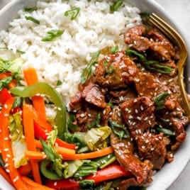 A plate of Instant Pot Mongolian Beef with peppers and rice.