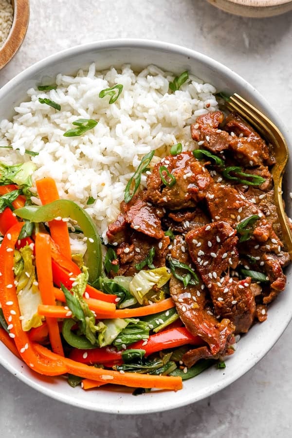 A plate of Instant Pot Mongolian Beef with peppers and rice.