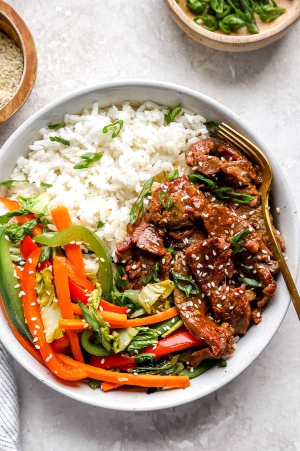 A plate of Instant Pot Mongolian Beef with peppers and rice.