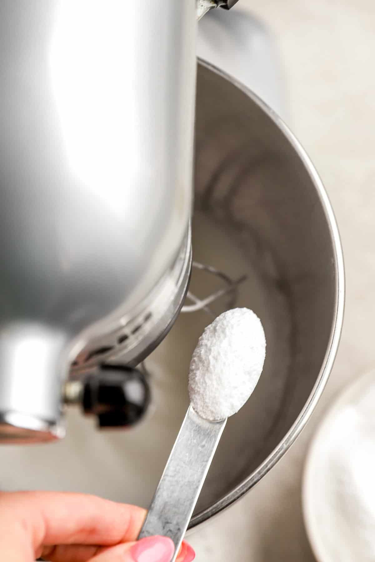 Sugar being added to whipped egg whites.