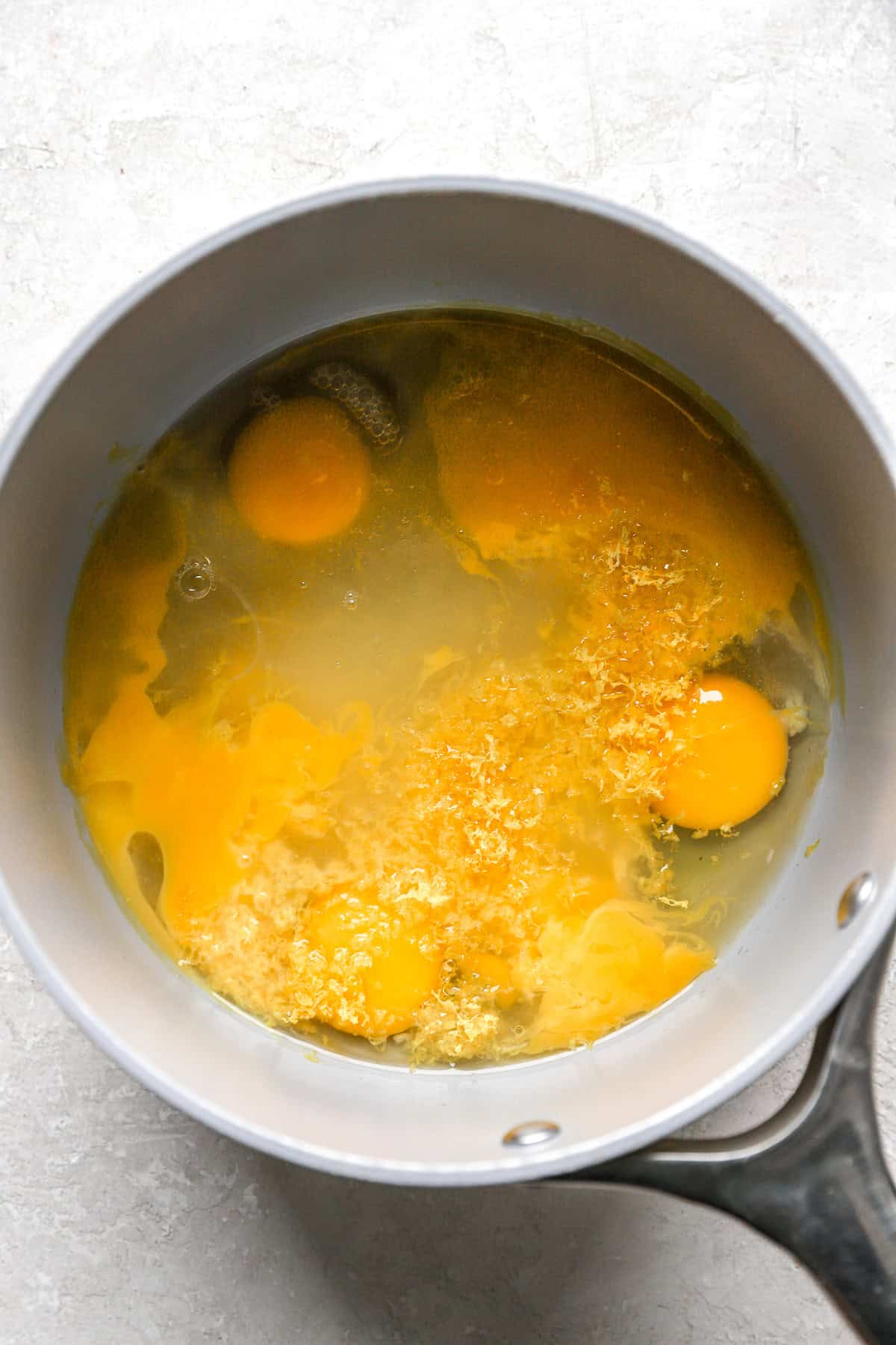 Eggs, sugar, lemon juice, lemon zest, and salt in a bowl.