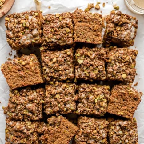 Pistachio cake cut into sixteen squares.