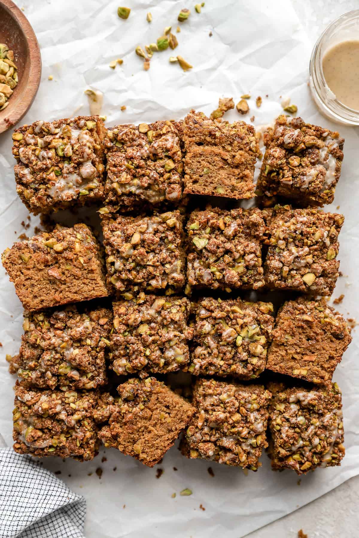 Pistachio cake cut into sixteen squares.