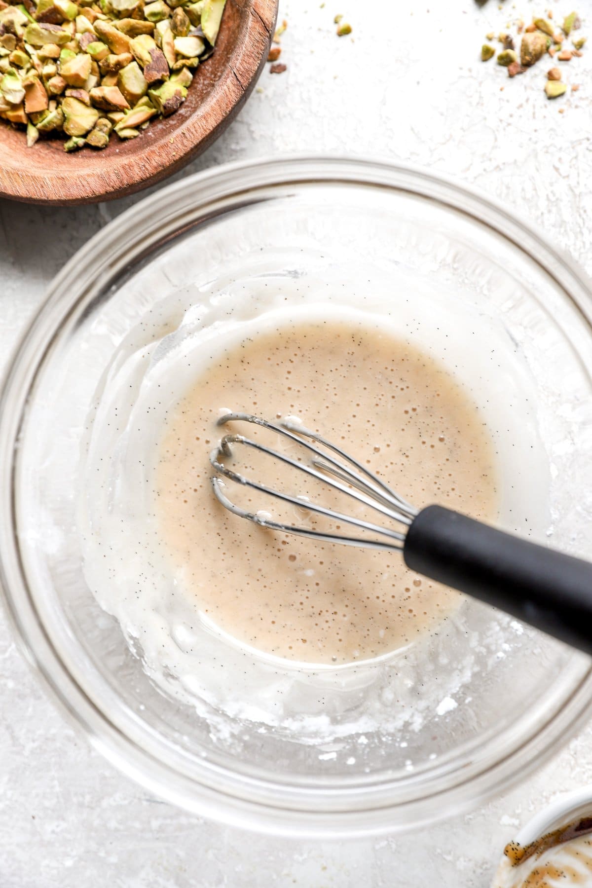 Vanilla glaze being whisked in a bowl. 
