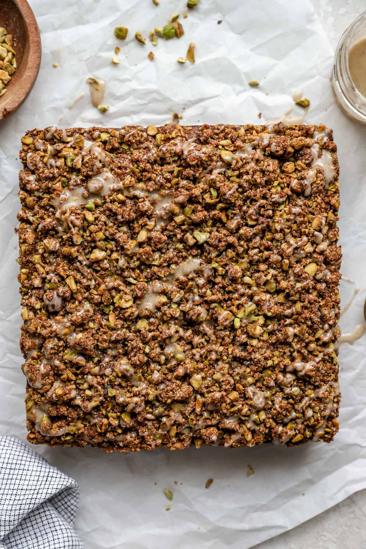 A pistachio cake with streusel and vanilla glaze. 