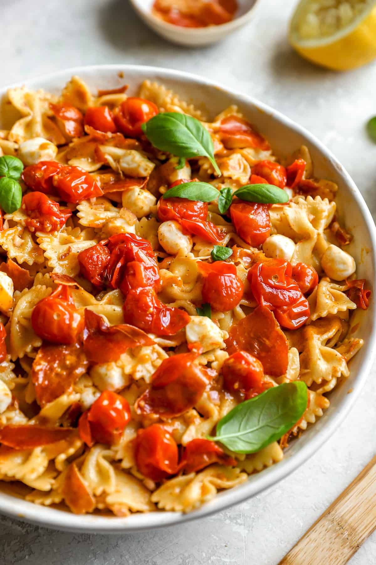 A bowl of caprese pasta salad.  