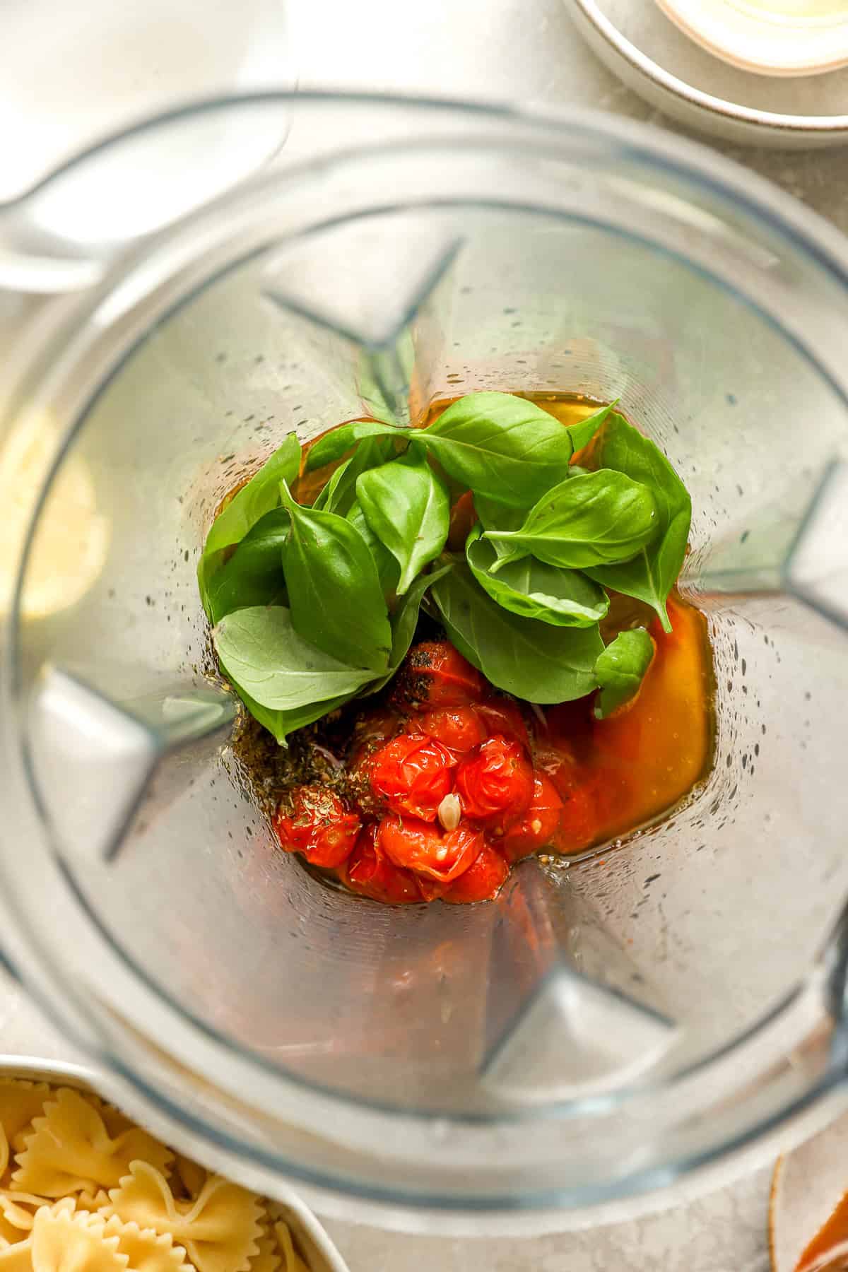 Tomato confit dressing ingredients in a blender. 