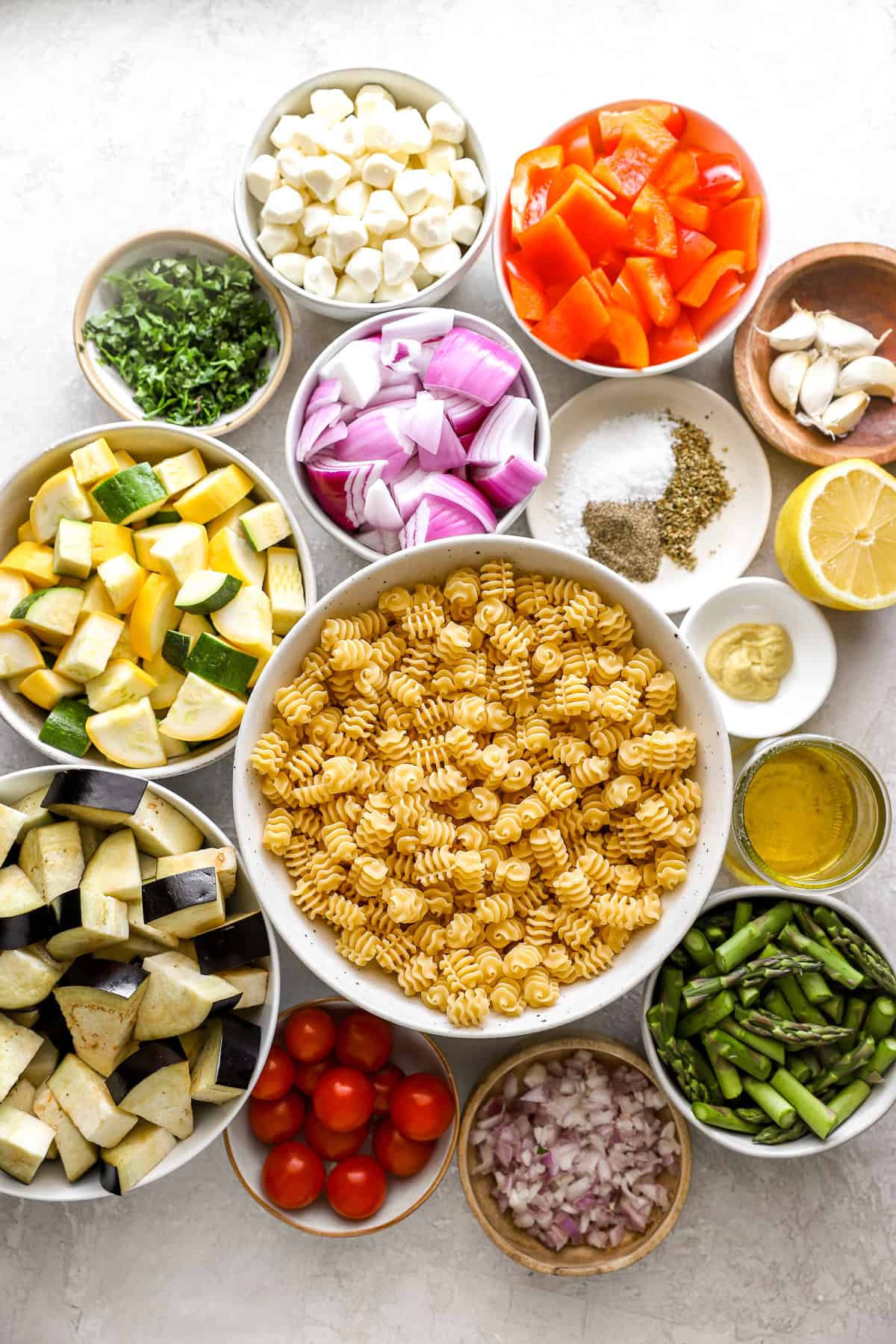Ingredients to make a Mediterranean pasta salad with roasted vegetables.