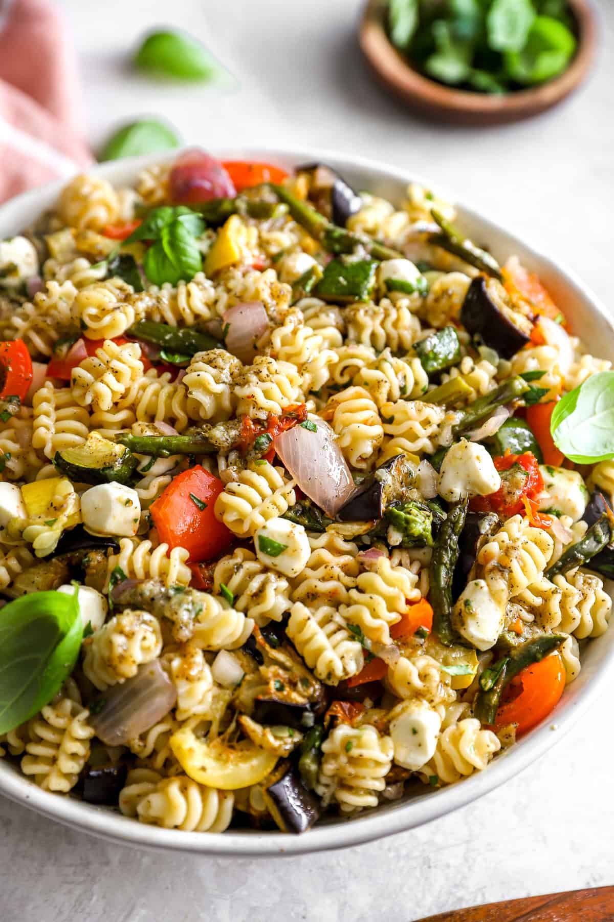 A bowl of Mediterranean pasta salad with roasted vegetables.
