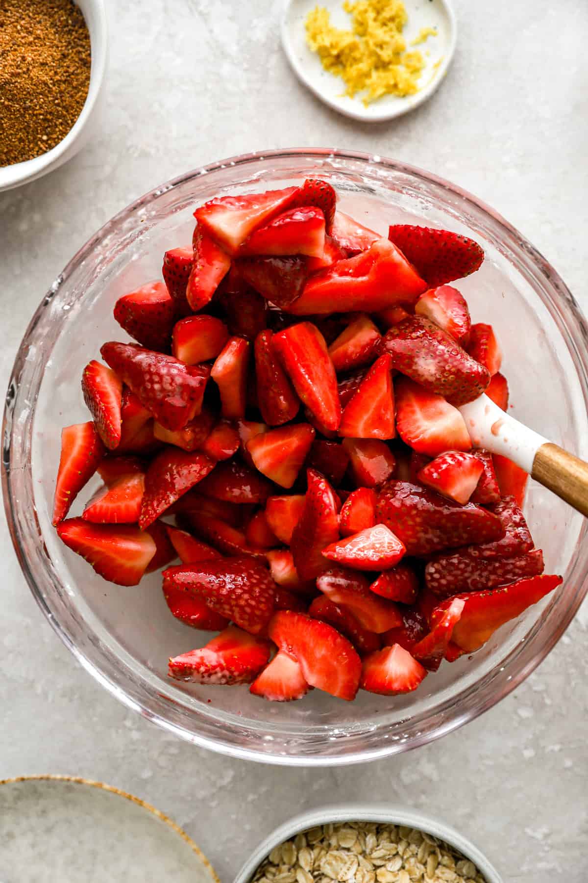 Strawberry crisp filling being stirred in a bowl. 