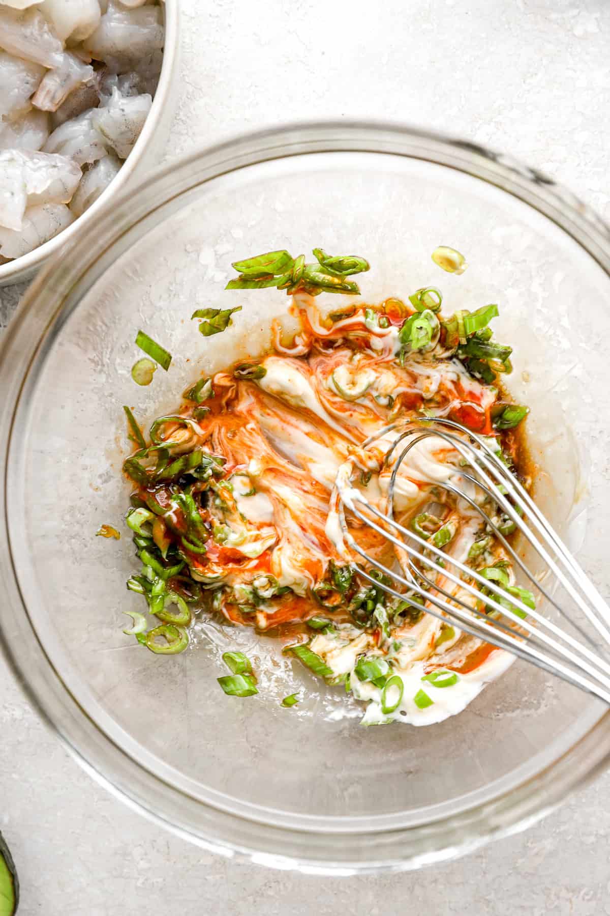 Spicy mayo being whisked in a bowl. 