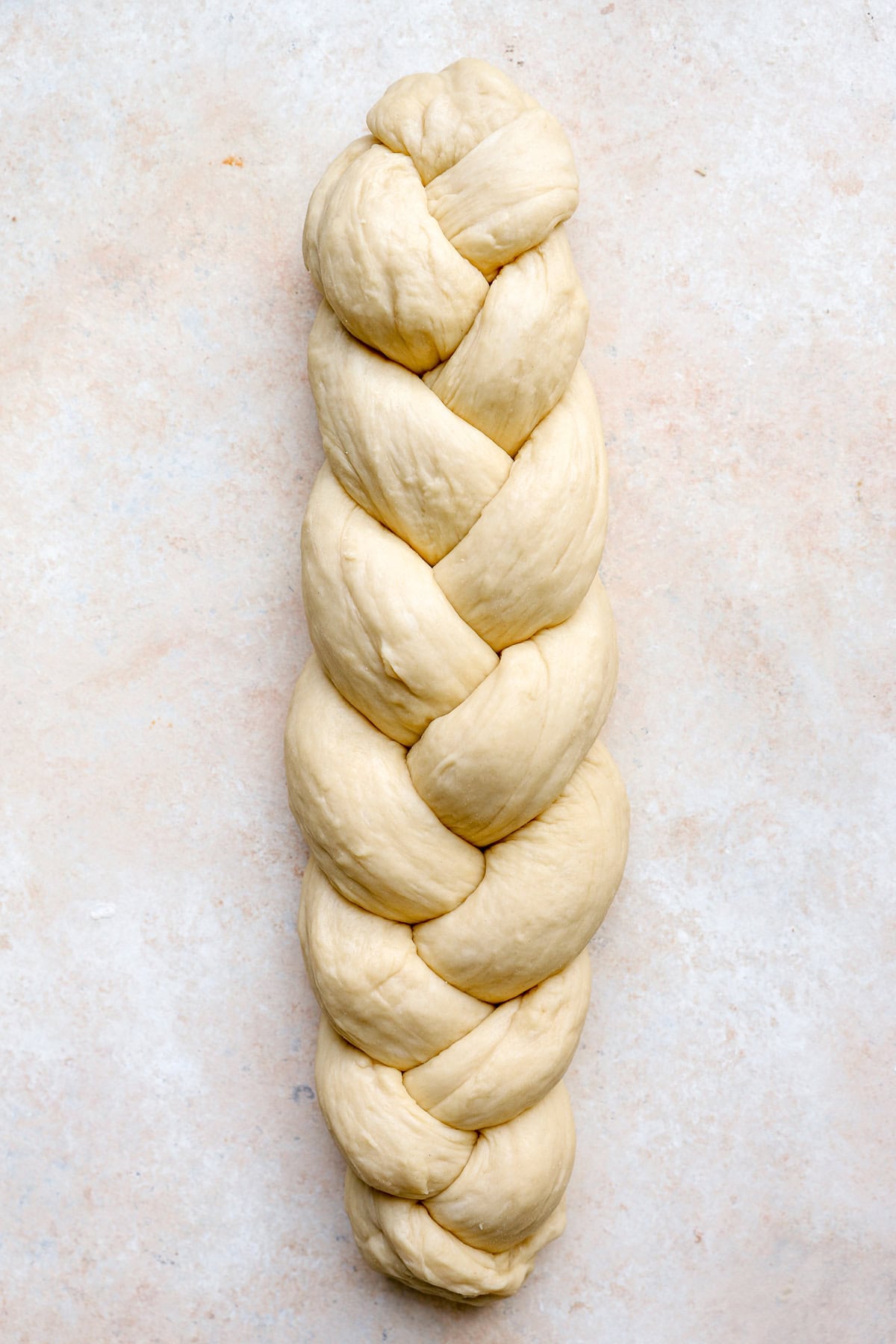 A raw braided loaf of Challah bread.