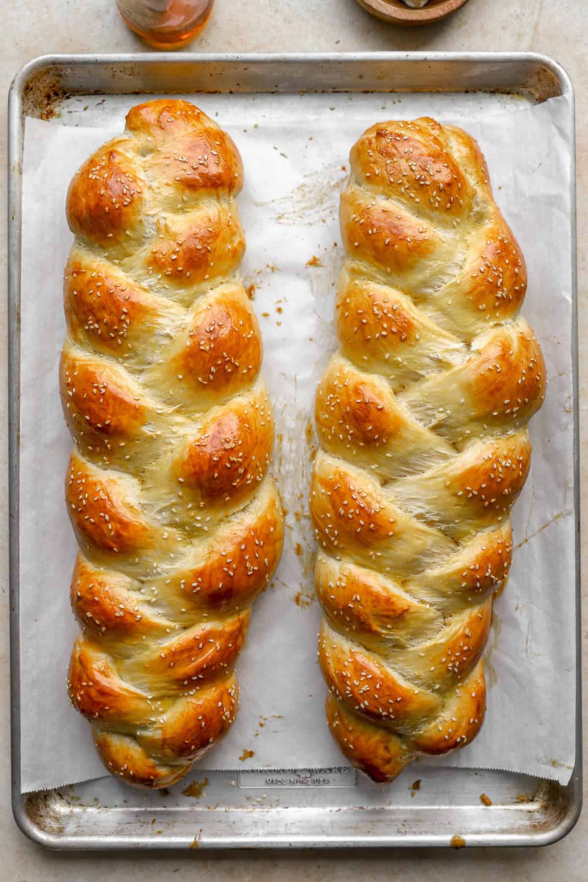 Two baked loaves of Challah bread dough.