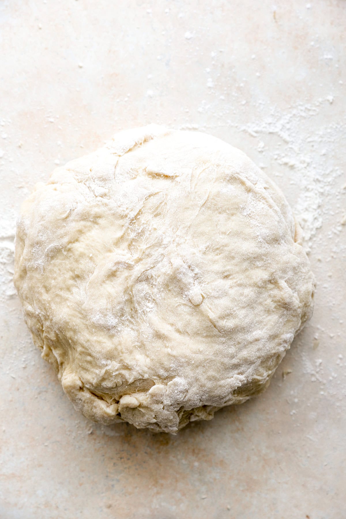 A ball of Challah bread dough on a counter.