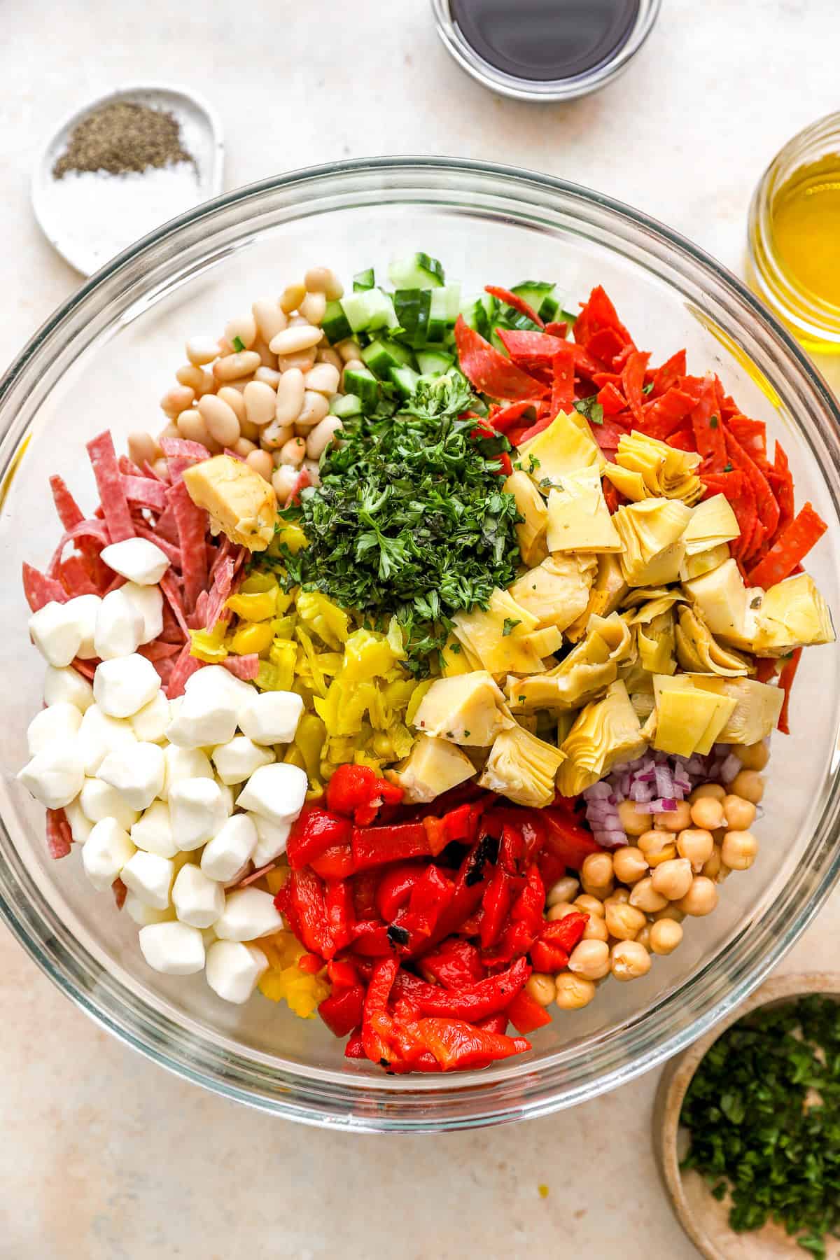 Grinder bean salad ingredients in a bowl. 