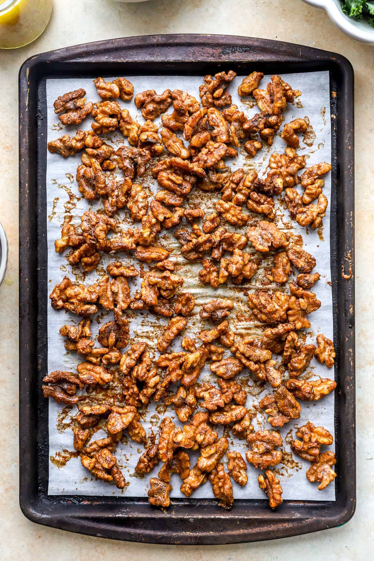 Roasted walnuts on a baking sheet.