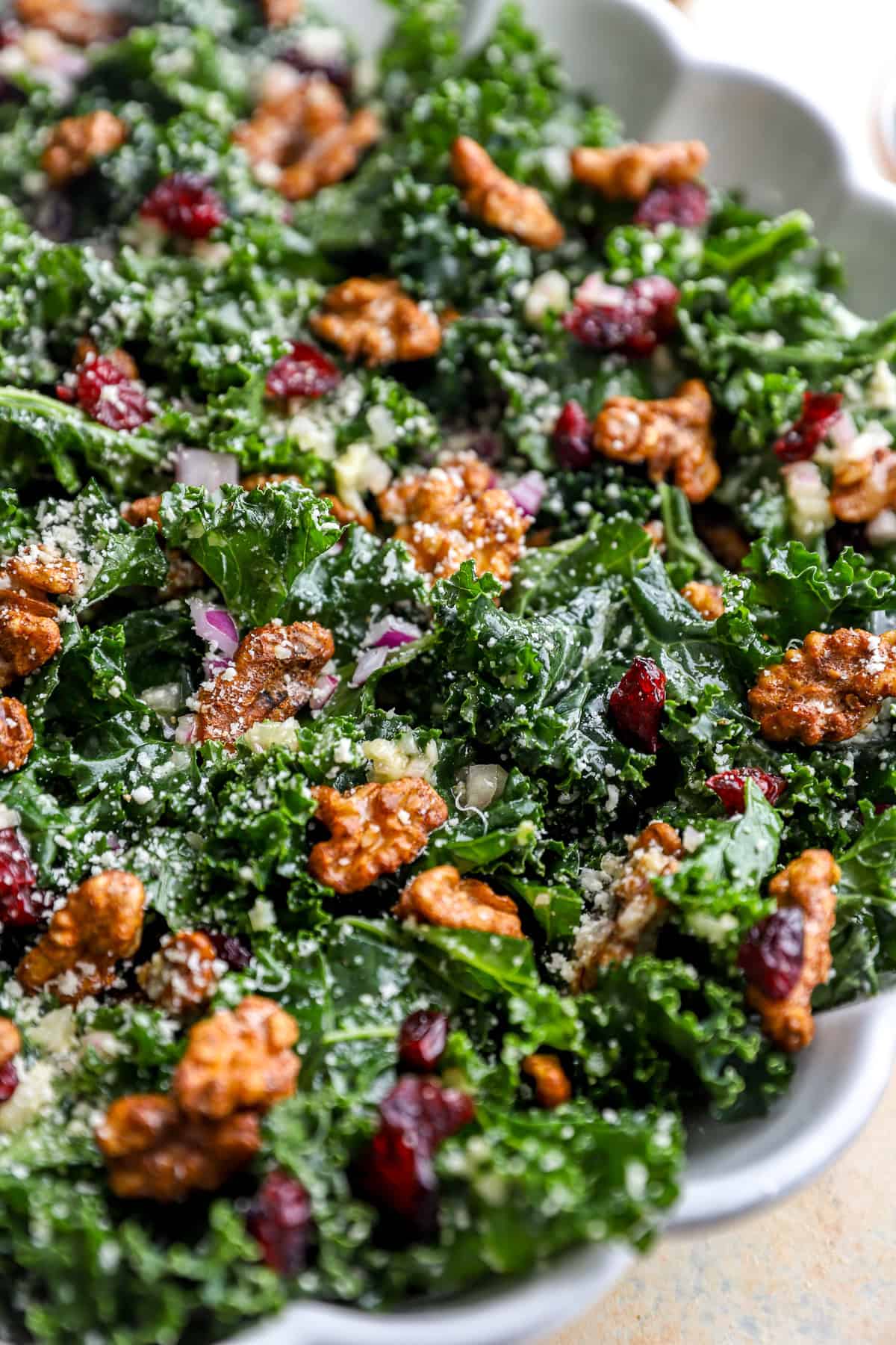 A fall kale salad with candied pecans, red onion, cheese, and shallot vinaigrette.