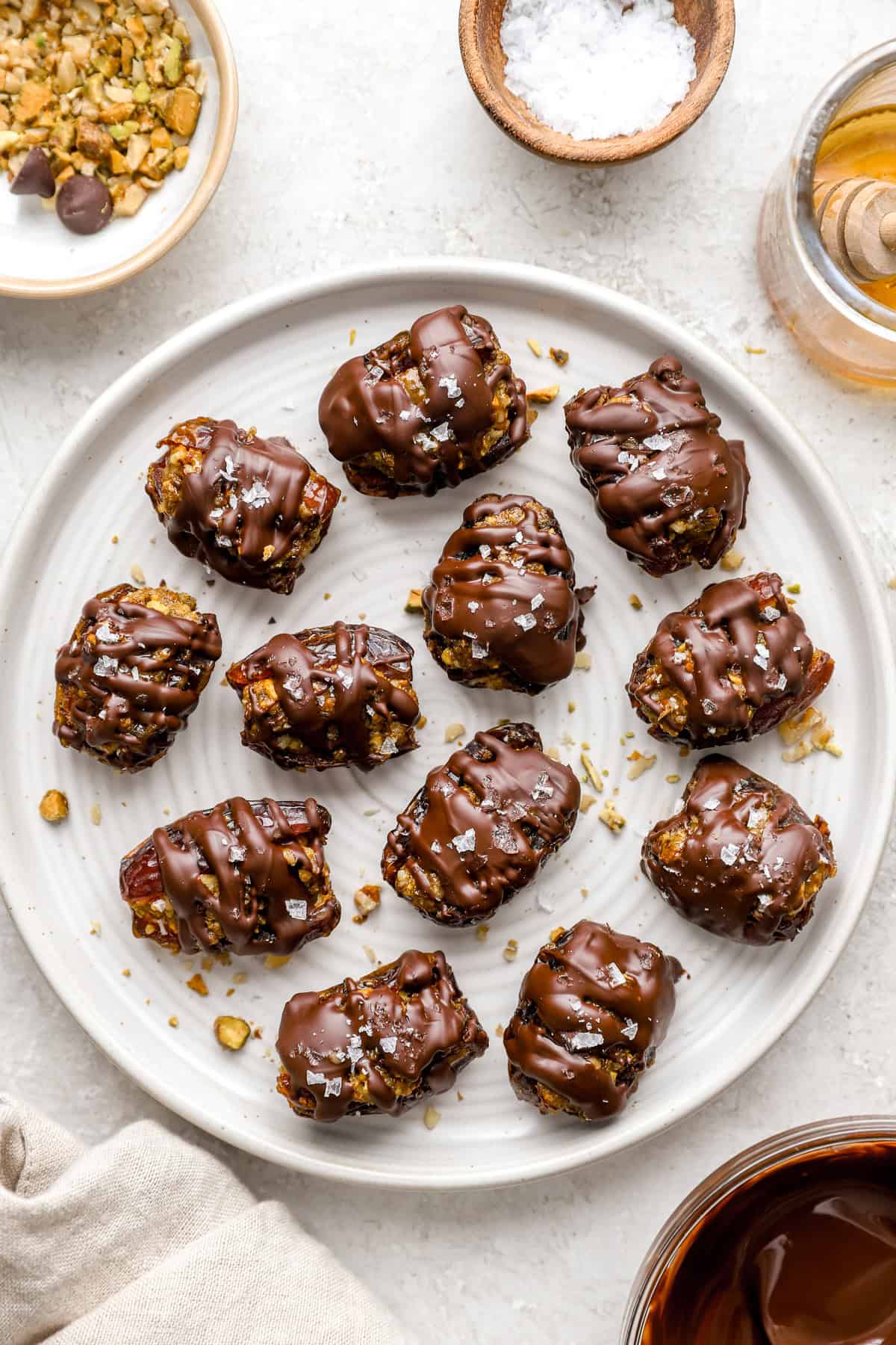 A plate of chocolate covered baklava stuffed dates.