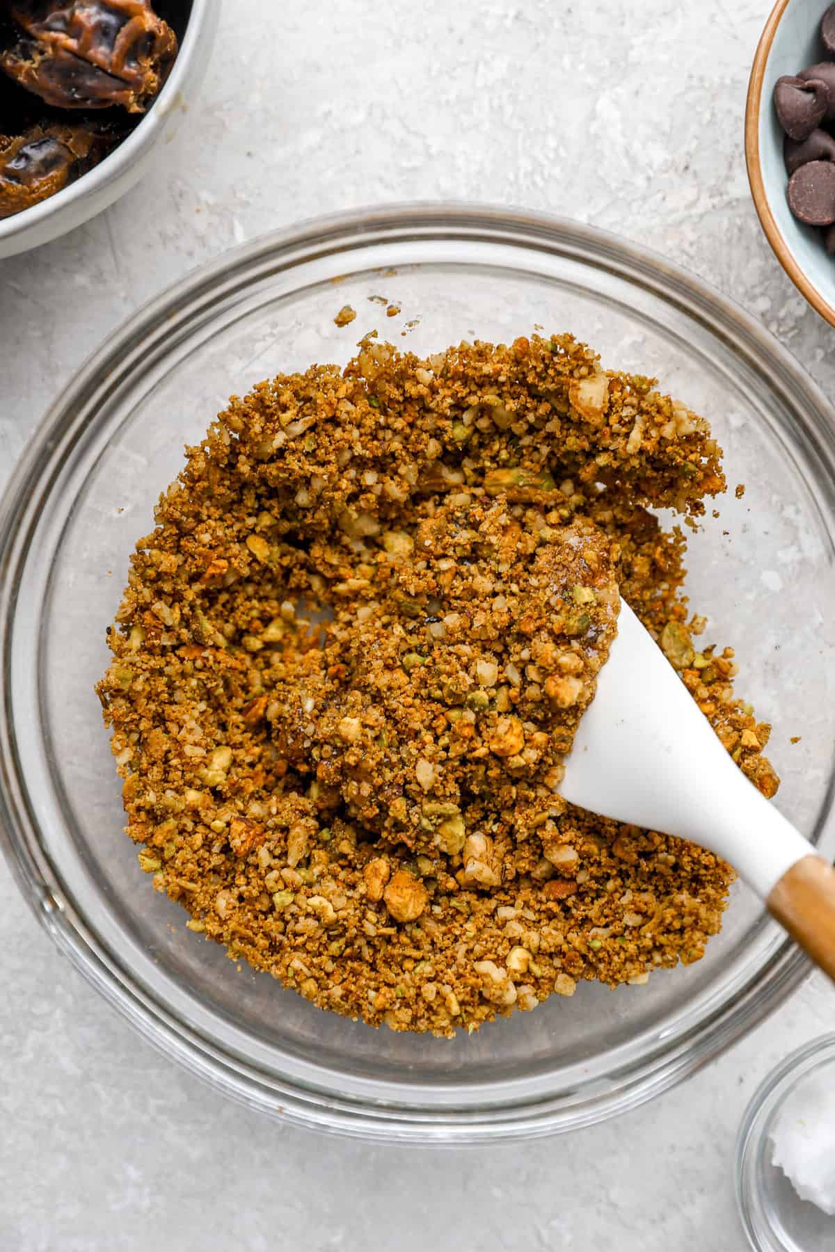 Honey being folded into a spiced nut mixture.
