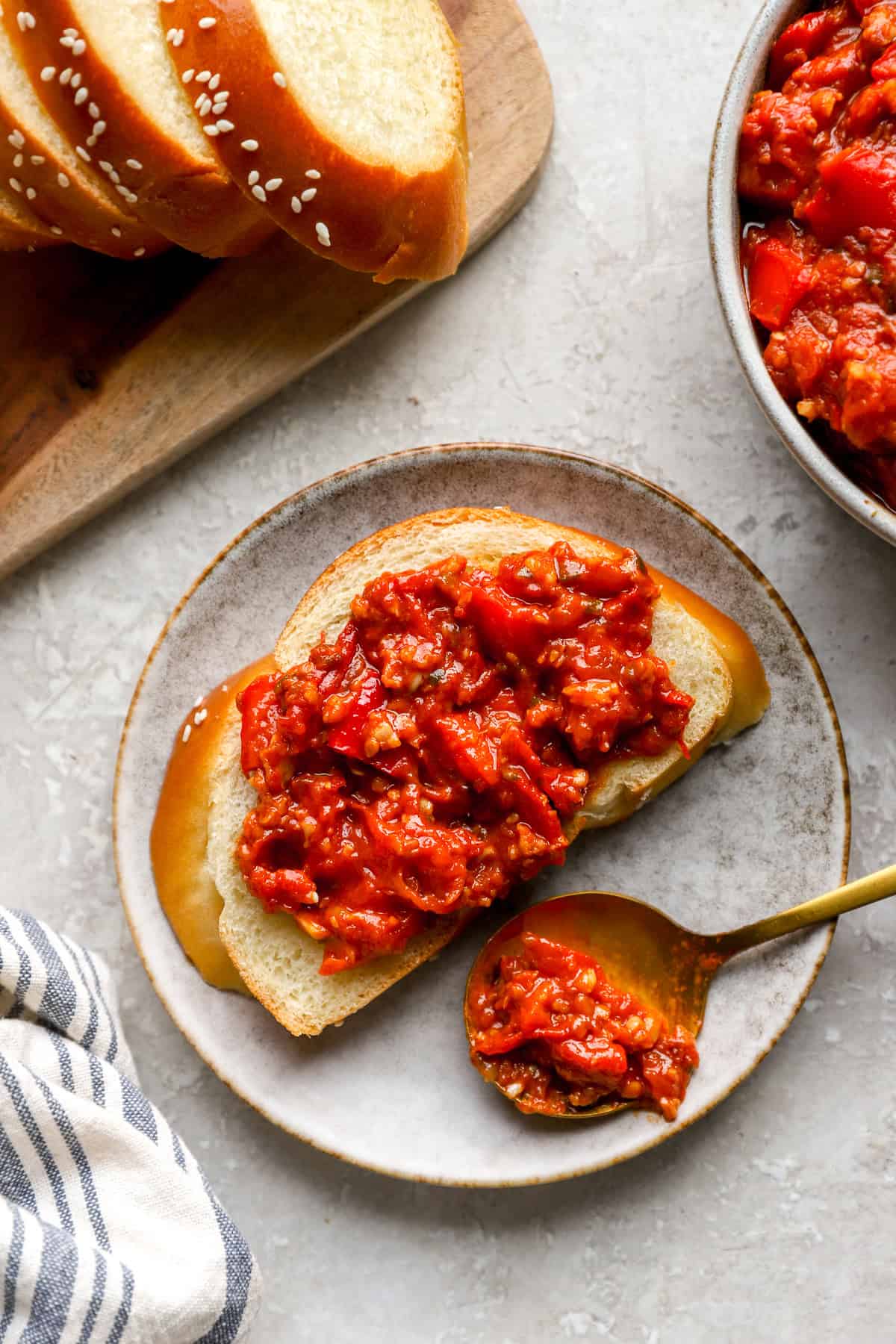 Matbucha spread over a slice of bread. 