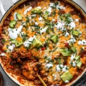 A beef enchilada skillet with a spoon sticking out.