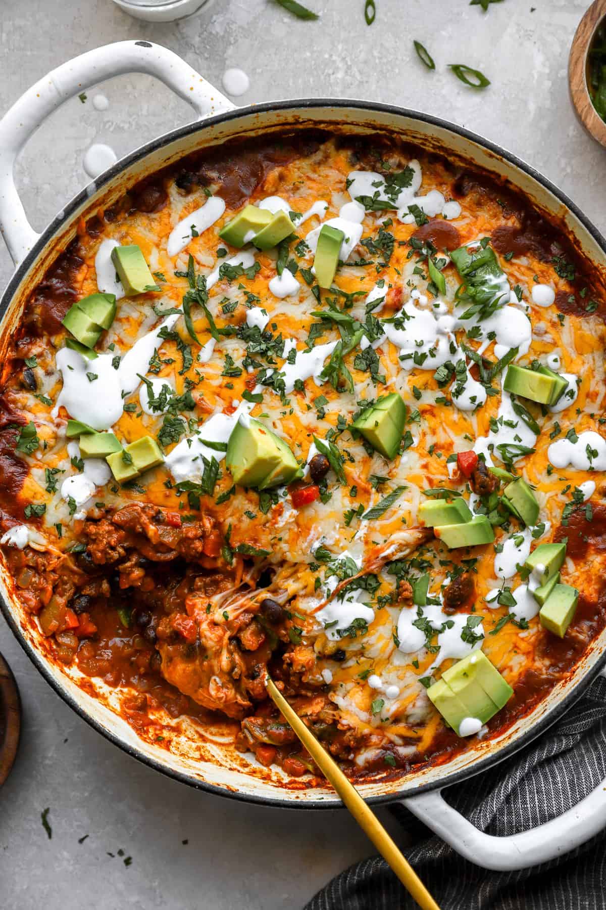 A beef enchilada skillet with a spoon sticking out.