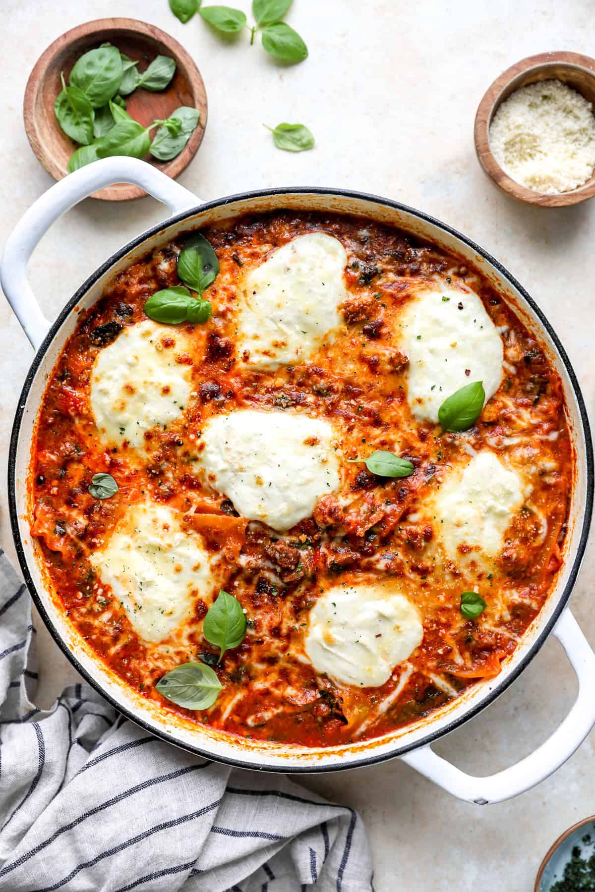 Skillet lasagna topped with red pepper flakes and basil.