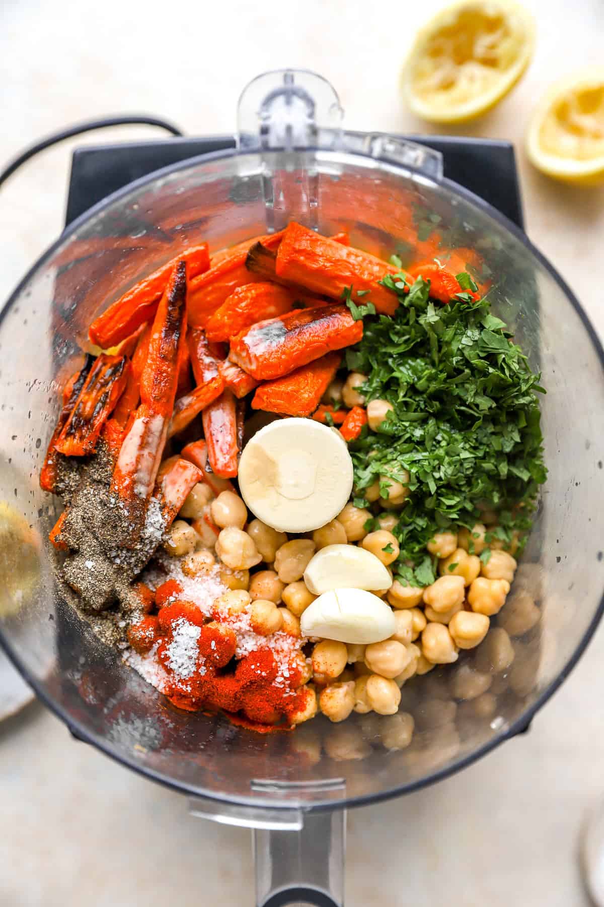 Roasted carrot hummus ingredients in a food processor.