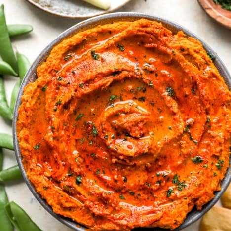 A bowl of roasted carrot hummus.