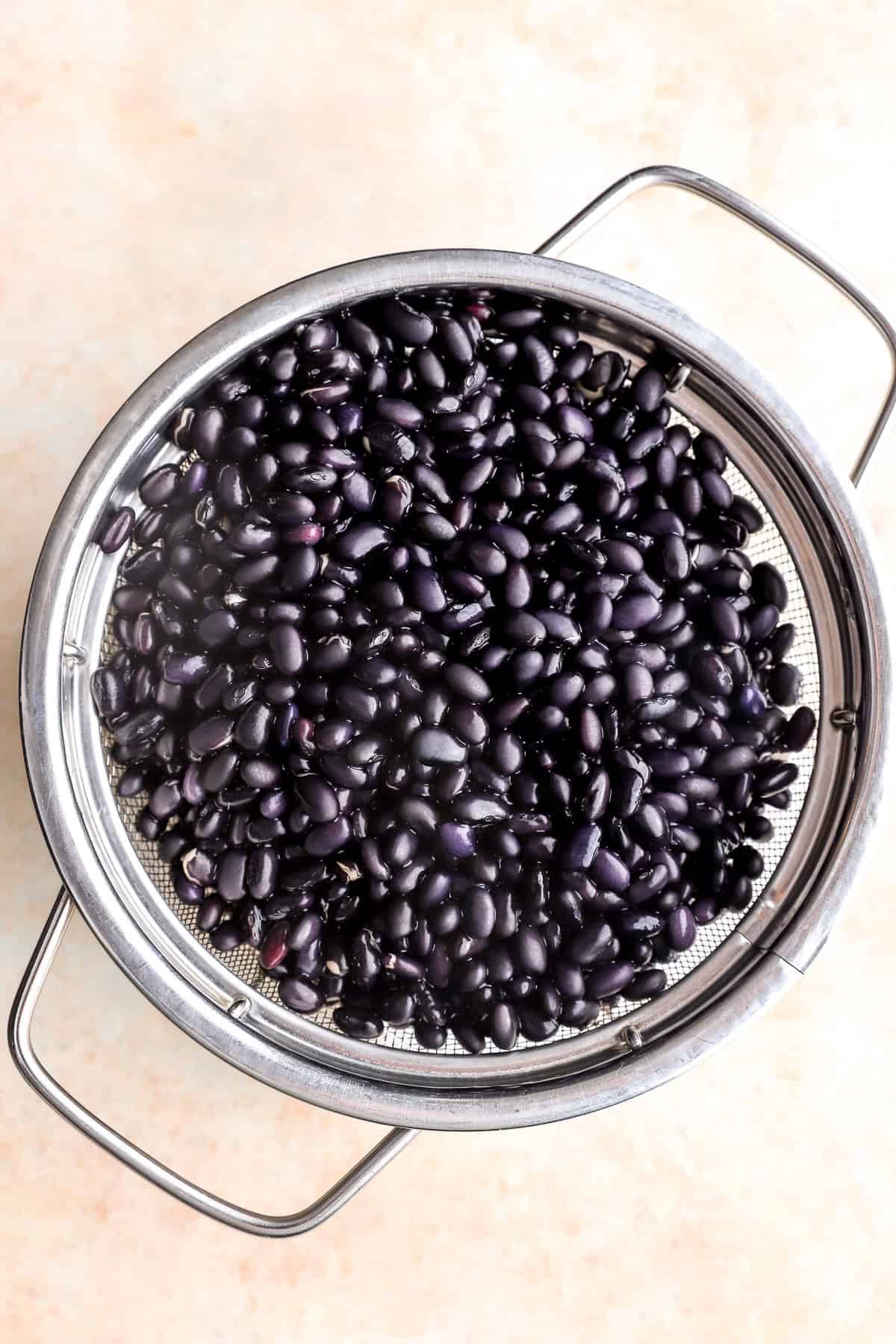 Black beans in a strainer. 