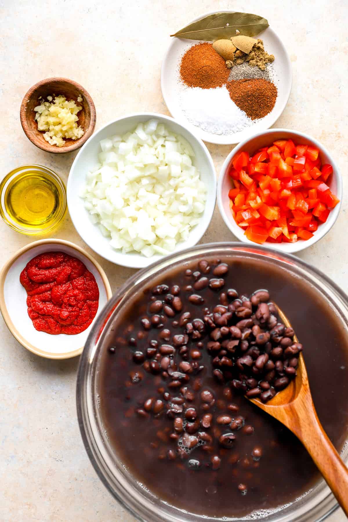 Black beans, bell peppers, onions, tomato paste, oil, garlic, and spices. 