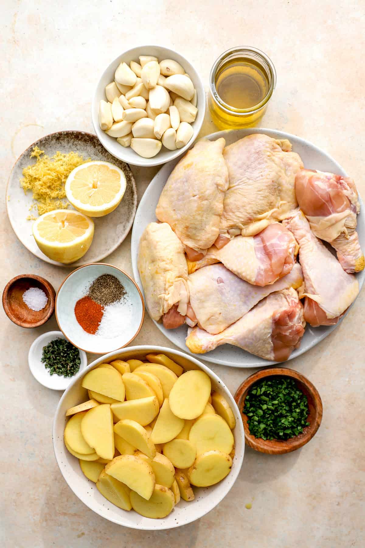 Ingredients to make garlic confit roasted chicken with potatoes.