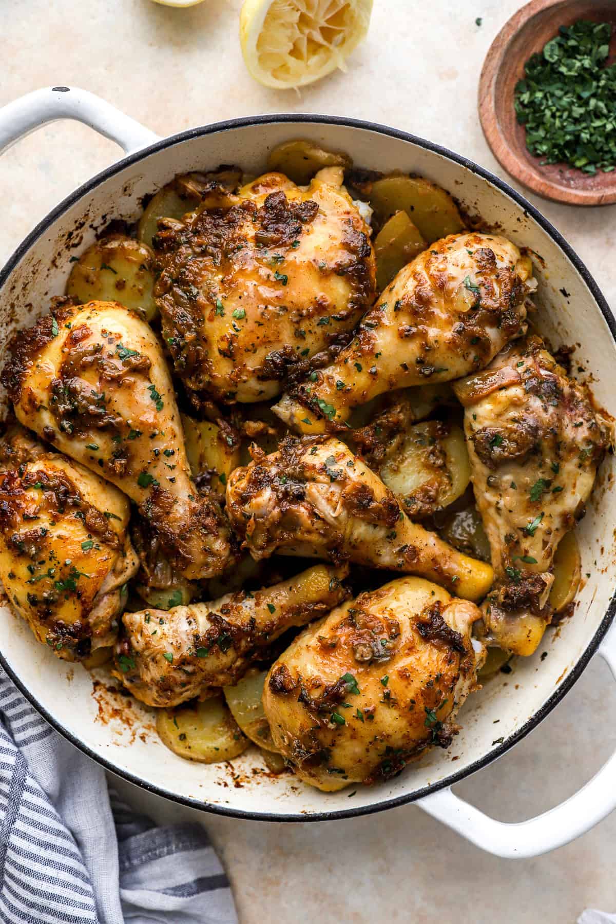 Baked garlic confit chicken with potatoes in a braising pan.