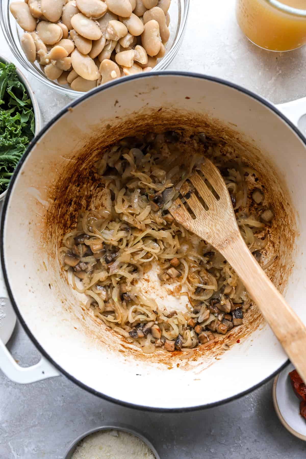 Aromatics being sautéed in a skillet. 