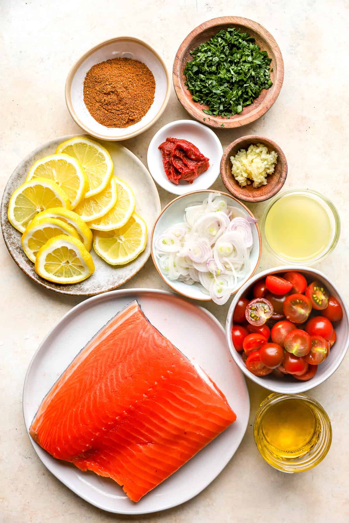 Oli, raw salmon, tomatoes, lemon juice, onions, lemon, tomato paste, garlic, parsley, and shawarma seasoning.