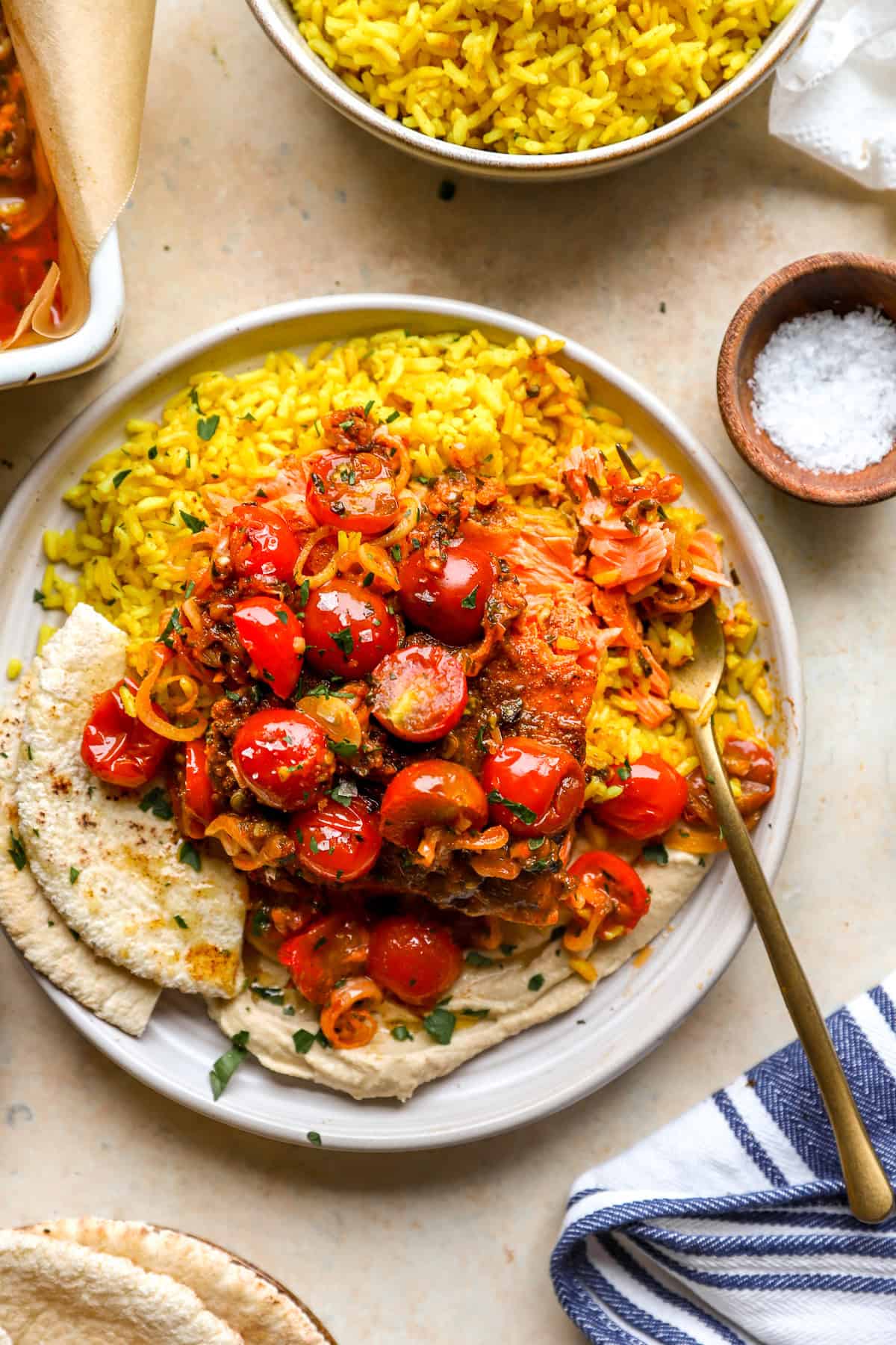 A plate of turmeric rice, pita bread, and salmon shawarma.