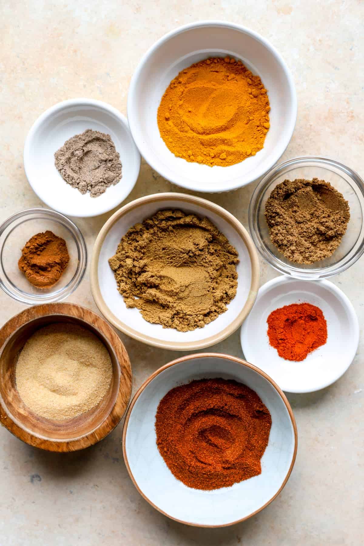 Bowls of spices to make homemade shawarma seasoning.