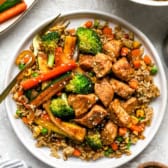 A plate of hibachi chicken and vegetables over hibachi rice.